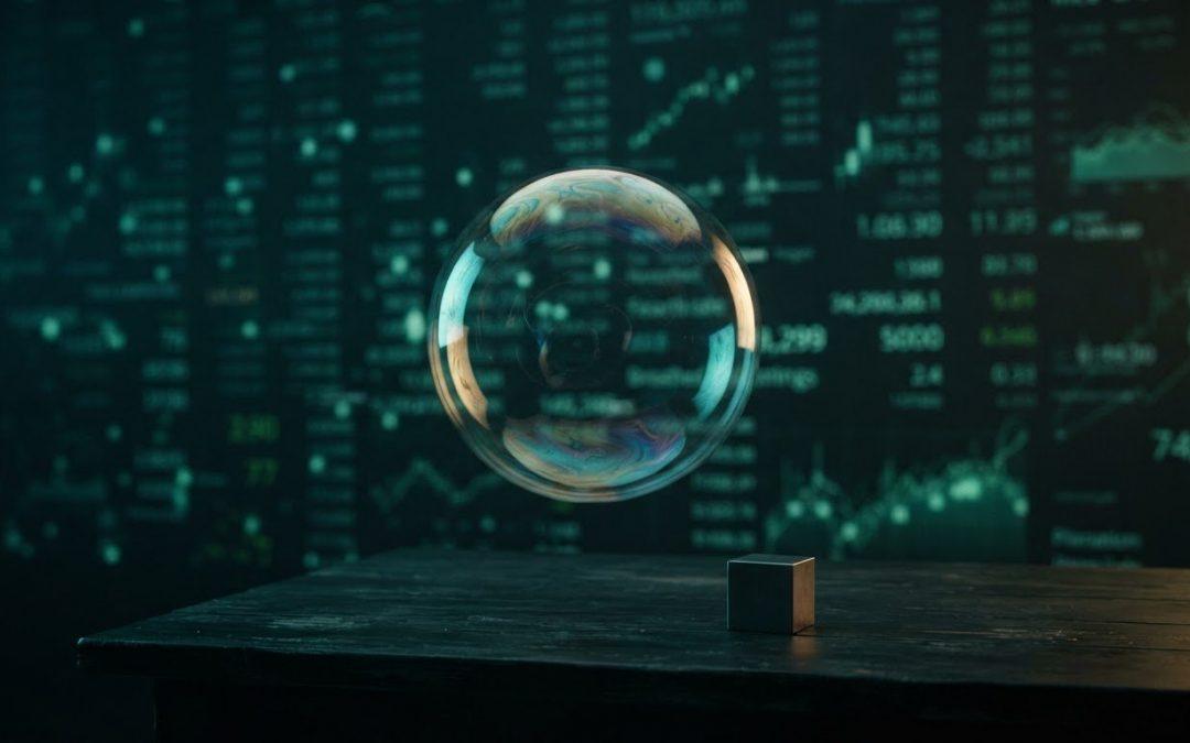 Schwebende Seifenblase vor digitaler Wand mit Börsendaten und kleinem Würfel auf Tisch